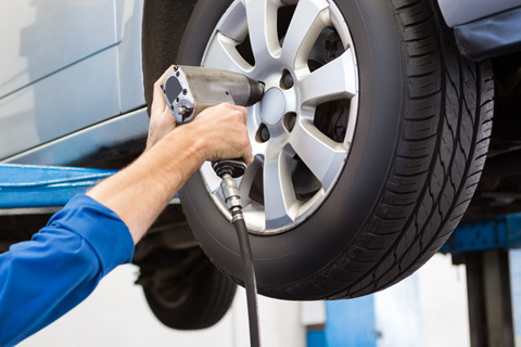 Mechanic Loosening Wheel Lug Nuts